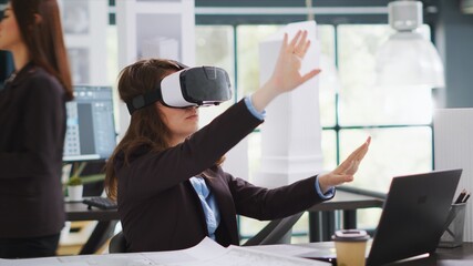 Fototapeta premium Architect designing project blueprints and plans with vr headset, using artificial intelligence to shape new property layout. Specialist working with virtual reality glasses at real estate agency.