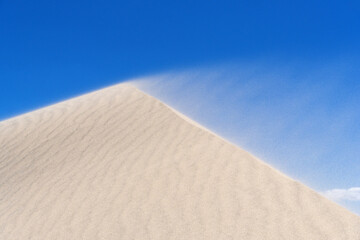 Sand Blowing Off The Crest Of A Dune