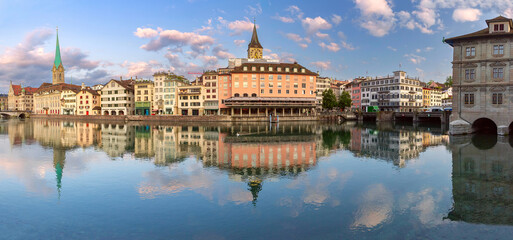 Panoramic view of Zurich waterfront with reflections of Fraumunster and St Peters Church, Switzerland