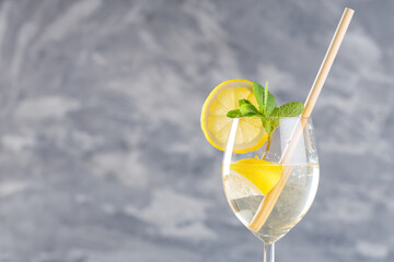 Hugo Sparkling Wine Cocktail with Fresh Mint and Lemon in Glass with Eco-Friendly Straw