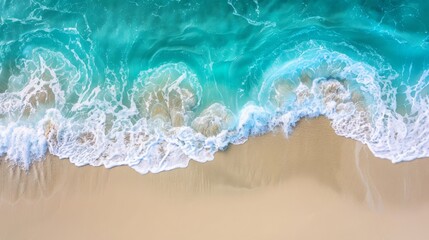 Sandy beach and soft blue ocean wave top view. Summer background