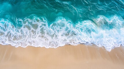 Obraz premium Sandy beach and soft blue ocean wave top view. Summer background