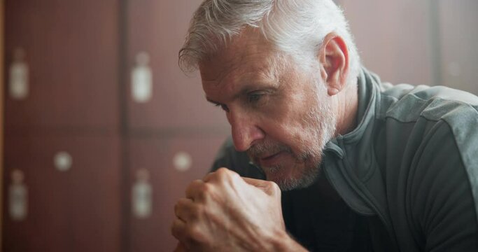 Locker room, man and thinking with pensive thoughts, contemplating and planning with ideas. Senior person, sports coach and solution for training, performance and game strategy in gym center