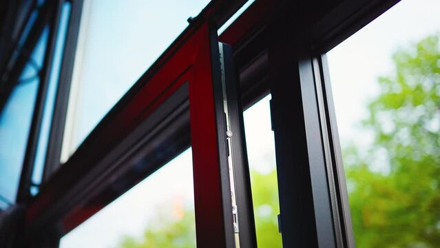 Captivating footage of a modern window frame in slow motion, with a blurred background for a serene and relaxing ambiance