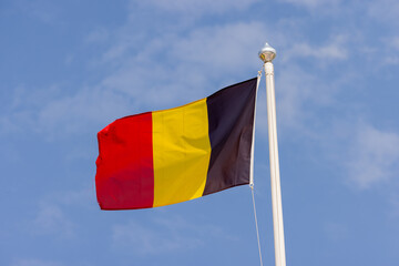 Photo of the Belgium Flag blowing in the wind on a sunny summers day