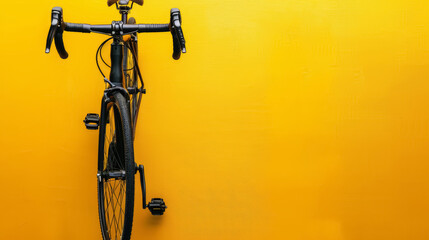 black urban bicycle against vibrant yellow wall background