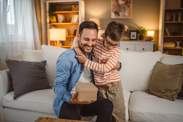 Son give gift his father and surprise him for birthday or fathers day