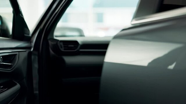 Man, opening and car door at dealer for test drive, retail or luxury shopping for transport choice. Male salesman, hand and professional service in showroom for purchase decision, career with auto