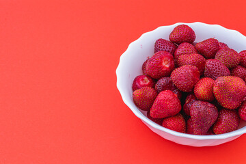 Delicious ripe strawberries on white plate, closeup