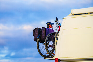 Camper van with bicycles on back rack.