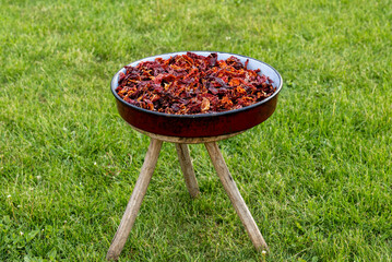 A full red casserole of red dried chili peppers that show off the texture and concept of the spice...