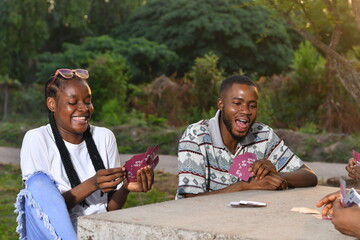 picture of african american friends and playing card games