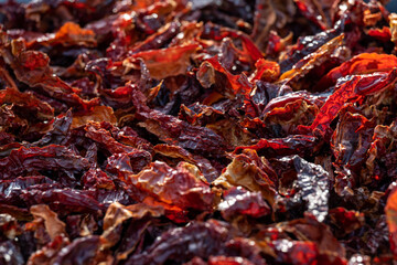 Top view of pile of dried red hot chili peppers. Hot peppers drying in the sun, showcasing texture and spicy ingredient concept.