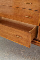 Classic walnut and pecan low dresser. Vintage Mid-century Modern furniture. Close-up detail photograph.