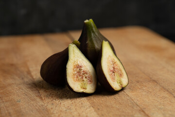 fresh figs on wooden table black background