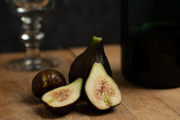 figs and wine bottle on a wooden table