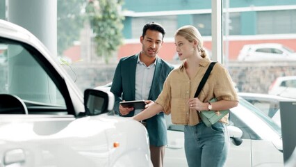 Woman, man and tablet in car dealership for sales, negotiation or consulting in vehicle finance. Conversation, salesman and customer shopping in transport showroom with digital app for auto insurance
