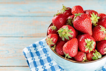 Fresh Ripe Red Strawberries in Bowl on Blue Checkered Cloth over Wooden Surface, Copy Space
