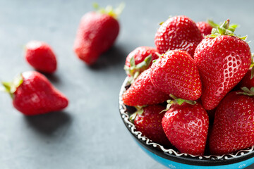 Fresh Red Strawberries in Bowl On Gray Concrete Background
