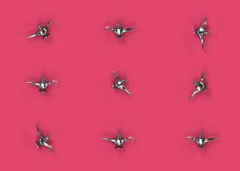 Silver oil lamp among many plain lamp, red background, 3d render