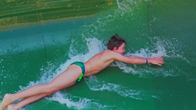 Abu Dhabi, United Arab Emirates - Jan 12 2024, 4k, The kid quickly slides down the water slide, at daytime, Abu Dhabi, United Arab Emirates 