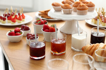 Different meals served on wooden table indoors. Buffet menu