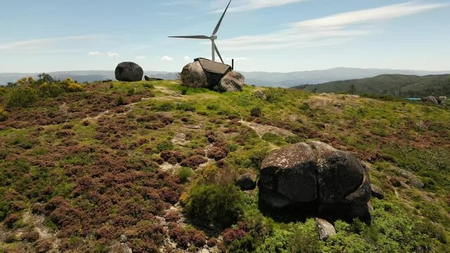 Aerial video above Casa do Penedo Boulder House in Fafe, Portugal