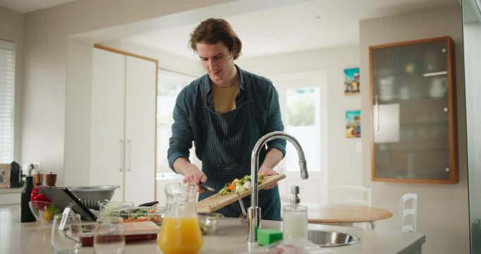 Tablet, cooking or man in home with healthy food for online recipe, wellness or dinner in kitchen. Vegan diet, natural nutrition or person on blog for lunch preparation for meal steps or dish tips