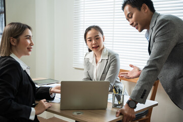 Asian business group discussing graph work at the office