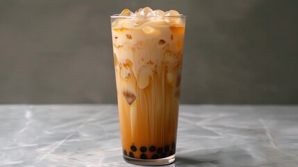 A cup of iced coffee with ice cubes and a straw
