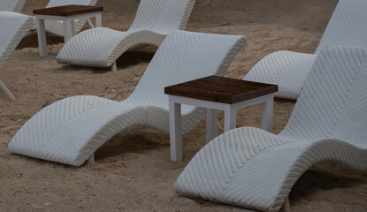 lounge chairs on a tropical sandy beach on a sunny holiday vacation at a tropical resort, summer...