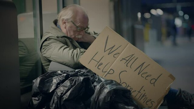 Elderly Homeless Man Suffering from Poverty Looking for Help at Train Station