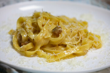 Traditional carbonara noodles on white plate