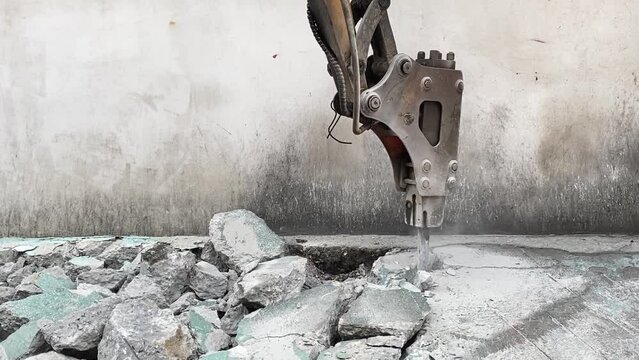 Closeup bucket of backhoe digging the soil at construction site. Crawler excavator digging on demolition site. Excavating machine. Earth moving equipment. Excavation vehicle. Construction business.