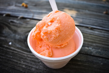 orange sherbet on a wooden table