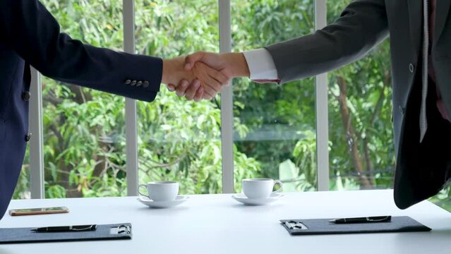 Businessman handshake manager recruitment team business. Partners shaking hands together greeting mergers and acquisitions. Shakehand Teamwork Partnership in office meeting room. Business concept