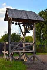 A simple man-made wooden belfry near the Orthodox village church