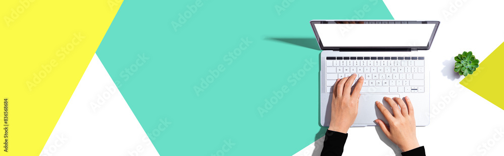 Poster person using a laptop computer from above