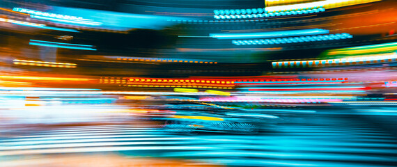 City motion blurred street intersection background at night