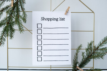 Preparation for winter holidays. SHOPPING LIST text on paper note. Celebration gifts and presents...