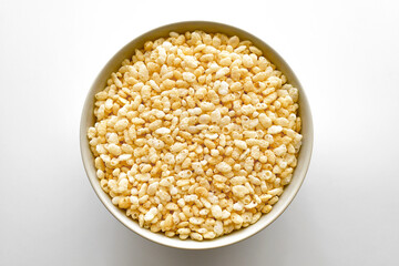 Crispy rice cereal in a white bowl. Flat lay top view photo. Food from above. 