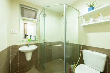  a clean, well-lit bathroom with modern fixtures, including a glass shower cubicle, toilet, bidet,...