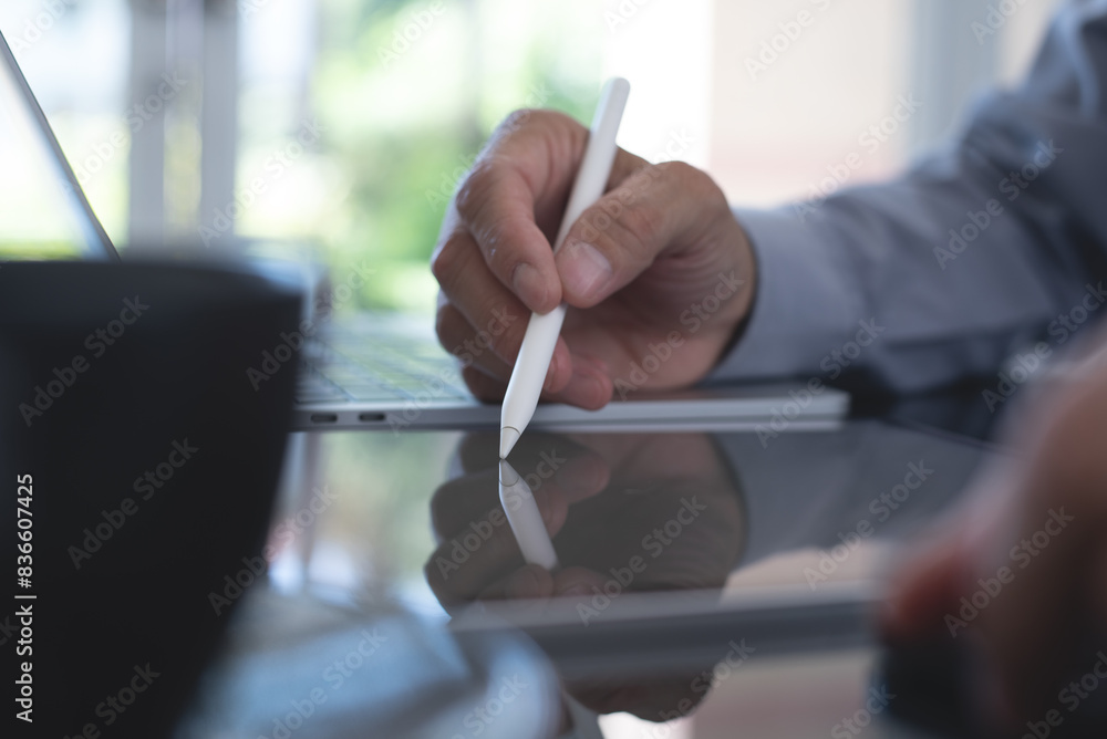 Aufkleber businessman using stylus pen signing e-document on digital tablet with laptop computer on table at m