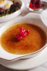  Caramel custard pudding on a plate on table 