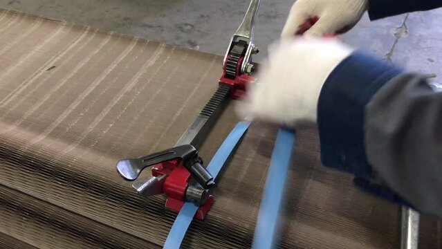 manual strapping of packages for shipping