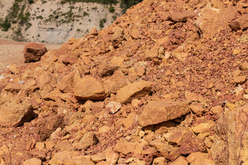 Bauxite red earth in front of the hillside.