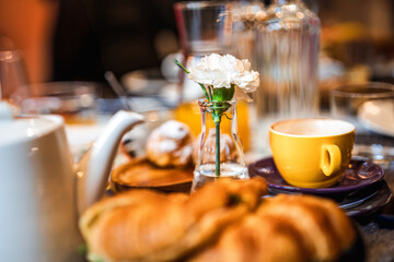 Morning breakfast table. Coffee cup and croissants.