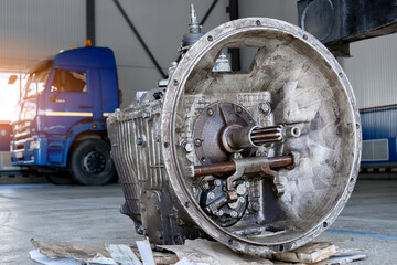 A disassembled industrial truck transmission awaiting repair or recycling, placed on a wooden...