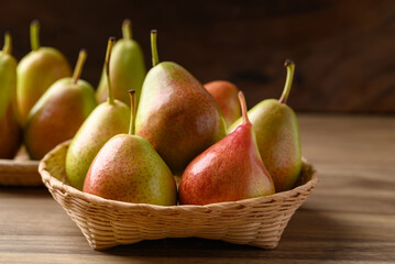Fresh pear fruit in natural basket on wooden background, Healthy fruit
