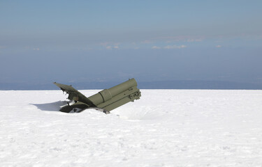 World War I cannon buried under a lot of fresh white snow in winter on the mountaintop